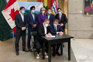Minister Holland signing Working Together Health Agreement with British Columbia