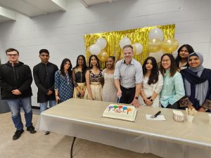 Mark joins the Ajax Constituency Youth Council to cut a cake at the Multicultural Night event