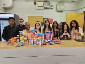 The Ajax Constituency Youth Council pose with food donations donated at their Multicultural Night event