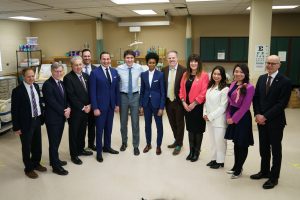 Prime Minister Justin Trudeau, Minister of Health Mark Holland and dignitaries from Manitoba stand in a circle in a hospital after announcing new health agreements