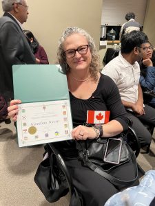 A proud woman shows off the certificate she received from MP Mark Holland